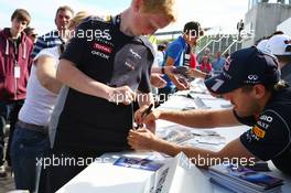 Sebastian Vettel (GER) Red Bull Racing signs autographs for the fans. 29.06.2013. Formula 1 World Championship, Rd 8, British Grand Prix, Silverstone, England, Qualifying Day.