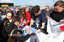 Kimi Raikkonen (FIN) Lotus F1 Team and team mate Romain Grosjean (FRA) Lotus F1 Team (Right) sign autographs for the fans. 29.06.2013. Formula 1 World Championship, Rd 8, British Grand Prix, Silverstone, England, Qualifying Day.