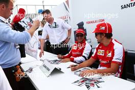 Fernando Alonso (ESP) Ferrari and team mate Felipe Massa (BRA) Ferrari sign autographs for the fans. 29.06.2013. Formula 1 World Championship, Rd 8, British Grand Prix, Silverstone, England, Qualifying Day.