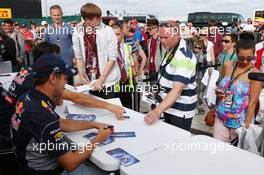 Sebastian Vettel (GER) Red Bull Racing and team mate Mark Webber (AUS) Red Bull Racing sign autographs for the fans. 29.06.2013. Formula 1 World Championship, Rd 8, British Grand Prix, Silverstone, England, Qualifying Day.