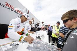 Adrian Sutil (GER) Sahara Force India F1 signs autographs for the fans. 29.06.2013. Formula 1 World Championship, Rd 8, British Grand Prix, Silverstone, England, Qualifying Day.