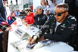 Lewis Hamilton (GBR) Mercedes AMG F1 signs autographs for the fans. 29.06.2013. Formula 1 World Championship, Rd 8, British Grand Prix, Silverstone, England, Qualifying Day.