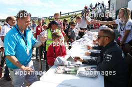 Lewis Hamilton (GBR) Mercedes AMG F1 signs autographs for the fans. 29.06.2013. Formula 1 World Championship, Rd 8, British Grand Prix, Silverstone, England, Qualifying Day.