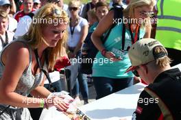 Kimi Raikkonen (FIN) Lotus F1 Team signs autographs for the fans. 29.06.2013. Formula 1 World Championship, Rd 8, British Grand Prix, Silverstone, England, Qualifying Day.