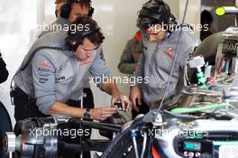 McLaren mechanics repair the McLaren MP4-28 of Sergio Perez (MEX) McLaren in the third practice session. 29.06.2013. Formula 1 World Championship, Rd 8, British Grand Prix, Silverstone, England, Qualifying Day.