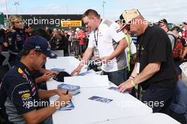Sebastian Vettel (GER) Red Bull Racing sign autographs for the fans. 29.06.2013. Formula 1 World Championship, Rd 8, British Grand Prix, Silverstone, England, Qualifying Day.