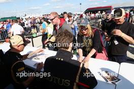 Kimi Raikkonen (FIN) Lotus F1 Team and team mate Romain Grosjean (FRA) Lotus F1 Team (Right) sign autographs for the fans. 29.06.2013. Formula 1 World Championship, Rd 8, British Grand Prix, Silverstone, England, Qualifying Day.