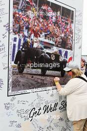 Fans sign a board containing messages of support for Murray Walker (GBR). 29.06.2013. Formula 1 World Championship, Rd 8, British Grand Prix, Silverstone, England, Qualifying Day.