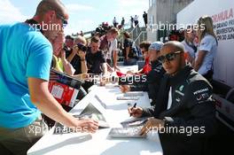 Lewis Hamilton (GBR) Mercedes AMG F1 signs autographs for the fans. 29.06.2013. Formula 1 World Championship, Rd 8, British Grand Prix, Silverstone, England, Qualifying Day.