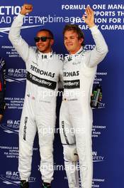 (L to R): Pole sitter Lewis Hamilton (GBR) Mercedes AMG F1 and second placed team mate Nico Rosberg (GER) Mercedes AMG F1 celebrate in parc ferme. 29.06.2013. Formula 1 World Championship, Rd 8, British Grand Prix, Silverstone, England, Qualifying Day.