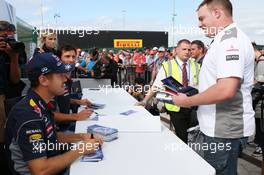 Sebastian Vettel (GER) Red Bull Racing sign autographs for the fans. 29.06.2013. Formula 1 World Championship, Rd 8, British Grand Prix, Silverstone, England, Qualifying Day.