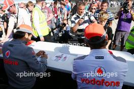 (L to R): Sergio Perez (MEX) McLaren and team mate Jenson Button (GBR) McLaren sign autographs for the fans. 29.06.2013. Formula 1 World Championship, Rd 8, British Grand Prix, Silverstone, England, Qualifying Day.