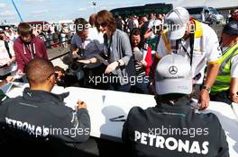 (L to R): Lewis Hamilton (GBR) Mercedes AMG F1 and team mate Nico Rosberg (GER) Mercedes AMG F1 sign autographs for the fans. 29.06.2013. Formula 1 World Championship, Rd 8, British Grand Prix, Silverstone, England, Qualifying Day.