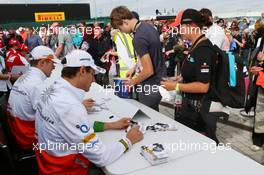 Paul di Resta (GBR) Sahara Force India F1 and Adrian Sutil (GER) Sahara Force India F1 (Right) sign autographs for the fans. 29.06.2013. Formula 1 World Championship, Rd 8, British Grand Prix, Silverstone, England, Qualifying Day.