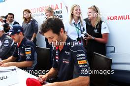 Mark Webber (AUS) Red Bull Racing and Sebastian Vettel (GER) Red Bull Racing sign autographs for the fans. 29.06.2013. Formula 1 World Championship, Rd 8, British Grand Prix, Silverstone, England, Qualifying Day.