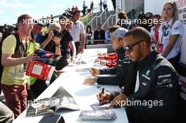 Lewis Hamilton (GBR) Mercedes AMG F1 signs autographs for the fans. 29.06.2013. Formula 1 World Championship, Rd 8, British Grand Prix, Silverstone, England, Qualifying Day.