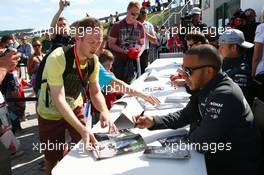 Lewis Hamilton (GBR) Mercedes AMG F1 signs autographs for the fans. 29.06.2013. Formula 1 World Championship, Rd 8, British Grand Prix, Silverstone, England, Qualifying Day.