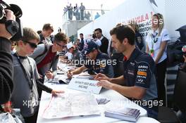 Mark Webber (AUS) Red Bull Racing and Sebastian Vettel (GER) Red Bull Racing sign autographs for the fans. 29.06.2013. Formula 1 World Championship, Rd 8, British Grand Prix, Silverstone, England, Qualifying Day.
