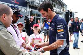 Mark Webber (AUS) Red Bull Racing signs autographs for the fans. 27.06.2013. Formula 1 World Championship, Rd 8, British Grand Prix, Silverstone, England, Preparation Day.