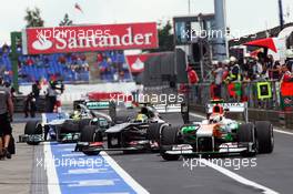 Adrian Sutil (GER) Sahara Force India VJM06, Esteban Gutierrez (MEX) Sauber C32 and Nico Rosberg (GER) Mercedes AMG F1 W04 enter the pits. 05.07.2013. Formula 1 World Championship, Rd 9, German Grand Prix, Nurburgring, Germany, Practice Day.