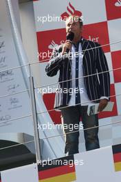 Kai Ebel (GER) RTL TV Presenter on the podium. 07.07.2013. Formula 1 World Championship, Rd 9, German Grand Prix, Nurburgring, Germany, Race Day.