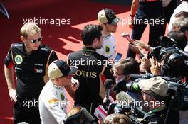 Kimi Raikkonen (FIN) Lotus F1 Team and Romain Grosjean (FRA) Lotus F1 Team with the media. 07.07.2013. Formula 1 World Championship, Rd 9, German Grand Prix, Nurburgring, Germany, Race Day.