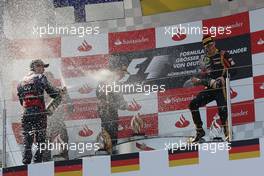 (L to R): race winner Sebastian Vettel (GER) Red Bull Racing celebrates on the podium with Kimi Raikkonen (FIN) Lotus F1 Team and Romain Grosjean (FRA) Lotus F1 Team. 07.07.2013. Formula 1 World Championship, Rd 9, German Grand Prix, Nurburgring, Germany, Race Day.