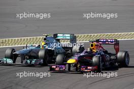 Sebastian Vettel (GER) Red Bull Racing RB9 and Lewis Hamilton (GBR) Mercedes AMG F1 W04 battle for position. 07.07.2013. Formula 1 World Championship, Rd 9, German Grand Prix, Nurburgring, Germany, Race Day.