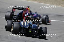 Sebastian Vettel (GER) Red Bull Racing RB9 leads Romain Grosjean (FRA) Lotus F1 E21. 07.07.2013. Formula 1 World Championship, Rd 9, German Grand Prix, Nurburgring, Germany, Race Day.