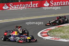 Sebastian Vettel (GER) Red Bull Racing RB9 leads Romain Grosjean (FRA) Lotus F1 E21 and Kimi Raikkonen (FIN) Lotus F1 E21. 07.07.2013. Formula 1 World Championship, Rd 9, German Grand Prix, Nurburgring, Germany, Race Day.