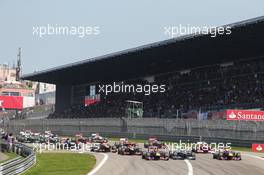 (L to R): Sebastian Vettel (GER) Red Bull Racing RB9, Lewis Hamilton (GBR) Mercedes AMG F1 W04 and Mark Webber (AUS) Red Bull Racing RB9 lead at the start of the race. 07.07.2013. Formula 1 World Championship, Rd 9, German Grand Prix, Nurburgring, Germany, Race Day.