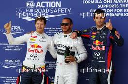 The top three qualifiers in Parc Ferme (L to R): Sebastian Vettel (GER) Red Bull Racing, second; Lewis Hamilton (GBR) Mercedes AMG F1, pole position; Mark Webber (AUS) Red Bull Racing, third. 06.07.2013. Formula 1 World Championship, Rd 9, German Grand Prix, Nurburgring, Germany, Qualifying Day.