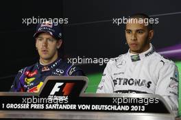 (L to R): Sebastian Vettel (GER) Red Bull Racing and pole sitter Lewis Hamilton (GBR) Mercedes AMG F1 in the FIA Press Conference. 06.07.2013. Formula 1 World Championship, Rd 9, German Grand Prix, Nurburgring, Germany, Qualifying Day.