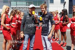 (L to R): Nico Rosberg (GER) Mercedes AMG F1 and Sebastian Vettel (GER) Red Bull Racing on the drivers parade. 07.07.2013. Formula 1 World Championship, Rd 9, German Grand Prix, Nurburgring, Germany, Race Day.