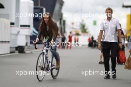 Jessica Michibata (JPN) rides a bicycle alongside boyfriend Jenson Button (GBR) McLaren. 04.07.2013. Formula 1 World Championship, Rd 9, German Grand Prix, Nurburgring, Germany, Preparation Day.