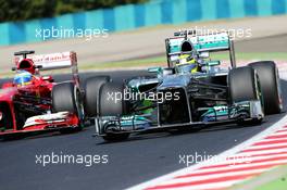 Nico Rosberg (GER) Mercedes AMG F1 W04 and Fernando Alonso (ESP) Ferrari F138. 26.07.2013. Formula 1 World Championship, Rd 10, Hungarian Grand Prix, Budapest, Hungary, Practice Day