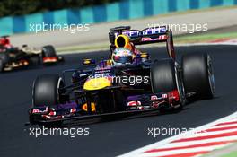 Sebastian Vettel (GER) Red Bull Racing RB9 watches Kimi Raikkonen (FIN) Lotus F1 E21 in his wing mirror. 26.07.2013. Formula 1 World Championship, Rd 10, Hungarian Grand Prix, Budapest, Hungary, Practice Day