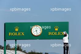 Rolex clock in the pits is cleaned. 26.07.2013. Formula 1 World Championship, Rd 10, Hungarian Grand Prix, Budapest, Hungary, Practice Day