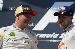 (L to R): second placed Kimi Raikkonen (FIN) Lotus F1 Team with third placed Sebastian Vettel (GER) Red Bull Racing on the podium. 28.07.2013. Formula 1 World Championship, Rd 10, Hungarian Grand Prix, Budapest, Hungary, Race Day