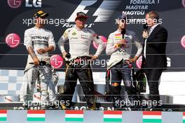 The podium (L to R): race winner Lewis Hamilton (GBR) Mercedes AMG F1; Kimi Raikkonen (FIN) Lotus F1 Team, second; Sebastian Vettel (GER) Red Bull Racing, third; Martin Brundle (GBR) Sky Sports Commentator. 28.07.2013. Formula 1 World Championship, Rd 10, Hungarian Grand Prix, Budapest, Hungary, Race Day