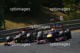 Sebastian Vettel (GER) Red Bull Racing RB9 and Romain Grosjean (FRA) Lotus F1 E21 battle for position. 28.07.2013. Formula 1 World Championship, Rd 10, Hungarian Grand Prix, Budapest, Hungary, Race Day