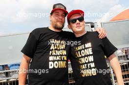 Kimi Raikkonen (FIN) Lotus F1 Team fans with 'Leave Me Alone - I Know What I am Doing' T-Shirts. 27.07.2013. Formula 1 World Championship, Rd 10, Hungarian Grand Prix, Budapest, Hungary, Qualifying Day