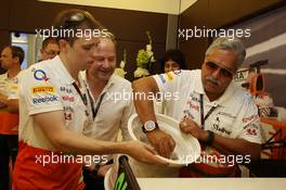 Dr. Vijay Mallya (IND) Sahara Force India F1 Team Owner signs a ceramic wheel rim to be presented to Adrian Sutil (GER) Sahara Force India F1 for his 100th GP. 28.07.2013. Formula 1 World Championship, Rd 10, Hungarian Grand Prix, Budapest, Hungary, Race Day