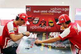 (L to R): Pedro De La Rosa (ESP) Ferrari Development Driver and Fernando Alonso (ESP) Ferrari play the Ferrari Shell Lego Challenge. 25.07.2013. Formula 1 World Championship, Rd 10, Hungarian Grand Prix, Budapest, Hungary, Preparation Day