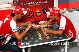 (L to R): Pedro De La Rosa (ESP) Ferrari Development Driver with Fernando Alonso (ESP) Ferrari play the Ferrari Shell Lego Challenge 25.07.2013. Formula 1 World Championship, Rd 10, Hungarian Grand Prix, Budapest, Hungary, Preparation Day