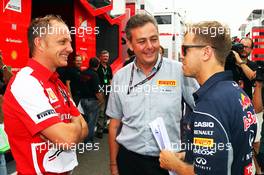 (L to R): Daniele Tartoni (ITA) Ferrari, with Mario Isola (ITA) Pirelli Racing Manager and Sebastian Vettel (GER) Red Bull Racing. 25.07.2013. Formula 1 World Championship, Rd 10, Hungarian Grand Prix, Budapest, Hungary, Preparation Day
