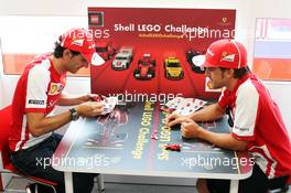 (L to R): Pedro De La Rosa (ESP) Ferrari Development Driver and Fernando Alonso (ESP) Ferrari play the Ferrari Shell Lego Challenge. 25.07.2013. Formula 1 World Championship, Rd 10, Hungarian Grand Prix, Budapest, Hungary, Preparation Day