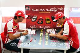 (L to R): Pedro De La Rosa (ESP) Ferrari Development Driver and Fernando Alonso (ESP) Ferrari play the Ferrari Shell Lego Challenge. 25.07.2013. Formula 1 World Championship, Rd 10, Hungarian Grand Prix, Budapest, Hungary, Preparation Day