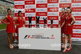 The podium trophies are presented by Airtel grid girls. 25.10.2013. Formula 1 World Championship, Rd 16, Indian Grand Prix, New Delhi, India, Practice Day.