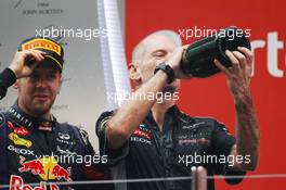 Race winner and World Champion Sebastian Vettel (GER) Red Bull Racing celebrates on the podium with Adrian Newey (GBR) Red Bull Racing Chief Technical Officer. 27.10.2013. Formula 1 World Championship, Rd 16, Indian Grand Prix, New Delhi, India, Race Day.